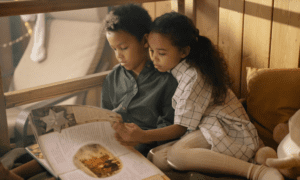 Children reading a book together to enrich knowledge