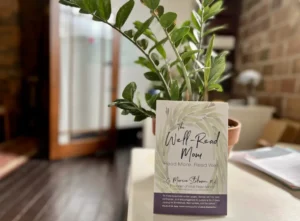 Well Read Mom Placard placed in front of a plant