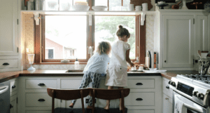 Children standing on the chair in the kitchen