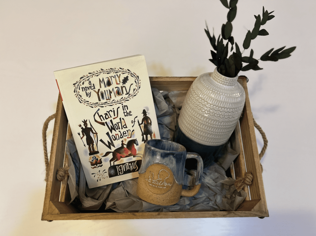 Charis's crate with a book and a mug.